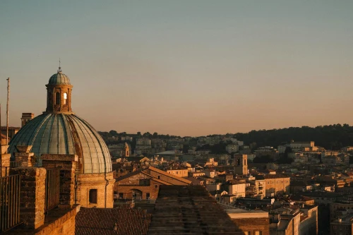 Aerial view of Ancona city with iconic dome at sunset, showcasing urban charm