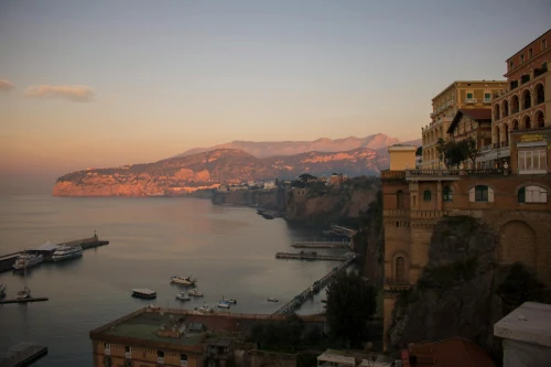 Golden hour view of Sorrento's coastline, capturing tranquil waters and iconic cliffs
