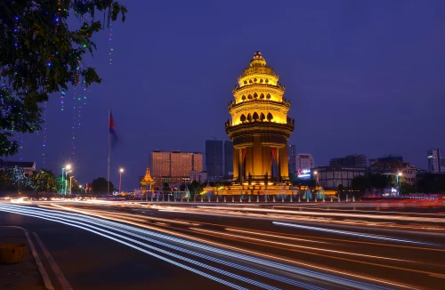 Long exposure night photograph of the illuminated Independence Monument with light streaks in Phnom Penh, Cambodia