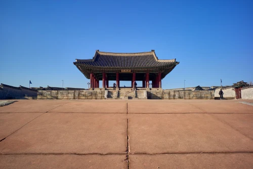 Front view of Gyeongbokgung Palace entrance with clear blue sky, showcasing traditional Korean architecture