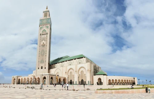 The iconic Hassan II Mosque in Casablanca under a blue sky, a key architectural masterpiece