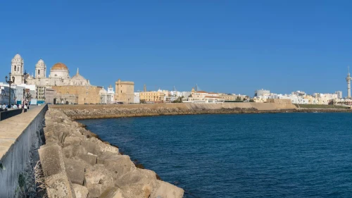 Panoramic seaside view of Cádiz with the Cathedral and ocean on a sunny day