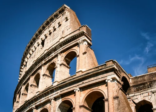 View of the iconic Colosseum in Rome, Italy, under a clear blue sky