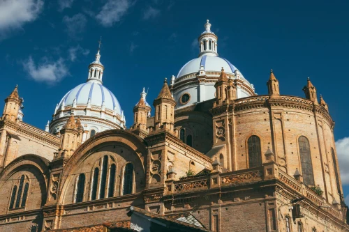 A stunning cathedral featuring exquisite blue domes under a clear blue sky, showcasing architectural brilliance