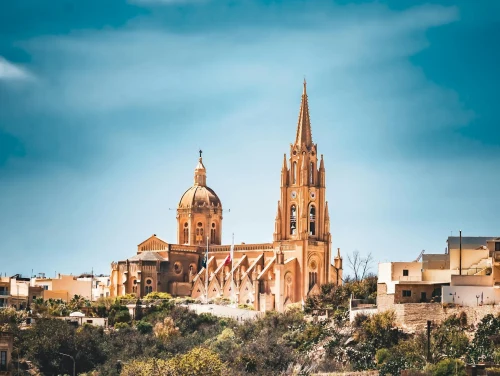 A stunning view of a historic cathedral with intricate architectural details under a clear blue sky
