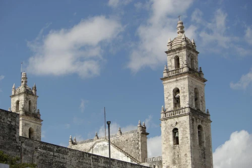 A scenic view of the historic cathedral towers against a clear blue sky in Merida, Mexico