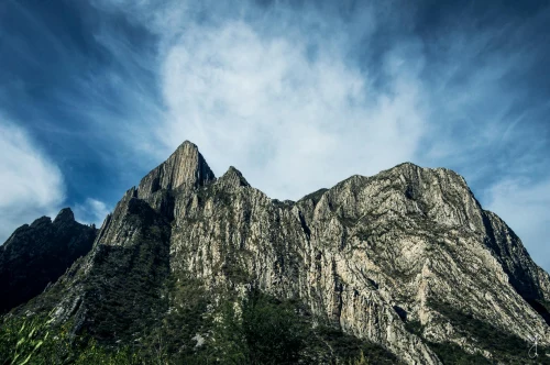 Majestic view of Monterrey's rocky mountain peaks against a blue sky. Perfect for adventure and nature themes