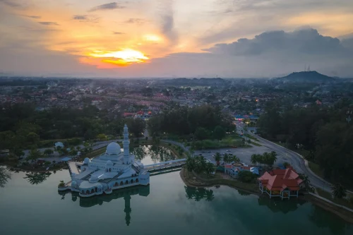 Drone shot of the scenic floating Tengku Tengah Zaharah Mosque, Malaysia, reflecting water
