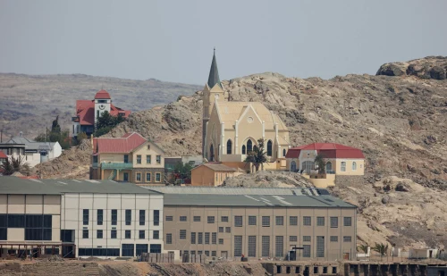 Iconic view of Tsumeb (TSB), namibia — A scenic view of charming colonial-style architecture in an arid desert village, showcasing a prominent church and rugged landscape..