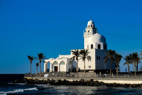 Scenic view of a beautiful mosque on a coastal promenade in Jeddah, Saudi Arabia against a clear blue sky