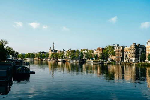 Beautiful view of Amsterdam's iconic canal and historic buildings on a sunny day