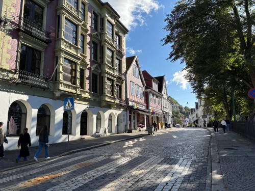 Cobblestone street with colorful buildings in Bergen, Norway, on a sunny day