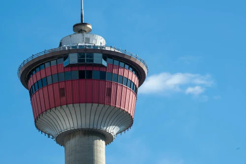 A detailed view of the iconic Calgary Tower set against a bright blue sky