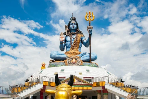 Stunning view of a grand Shiva statue in Pokhara, Nepal, with vibrant blue sky and detailed craftsmanship