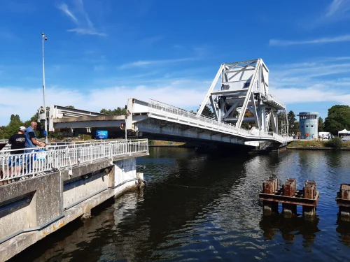 A sunny view of the iconic Sainte-Mère-Église bridge and nearby tower in Normandy, France