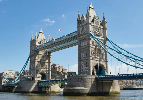 Iconic Tower Bridge in London, England, captured under a clear blue sky, showcasing its historic architecture