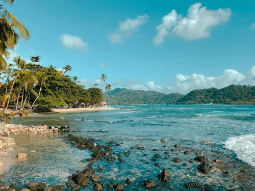 Explore the tranquil beauty of Colón's pristine beach, surrounded by lush greenery