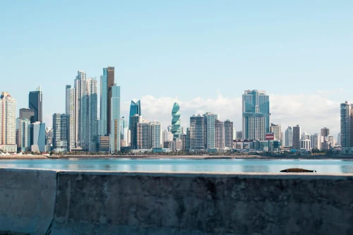 Panama City skyline under clear blue sky, viewed from waterfront showing iconic skyscrapers