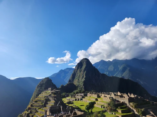 Sunny day at Machu Picchu with clear blue skies and ancient ruins