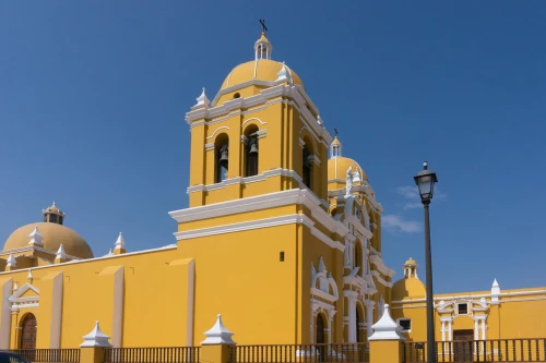 Beautiful day view of the vibrant yellow cathedral in Trujillo, Peru against a clear blue sky