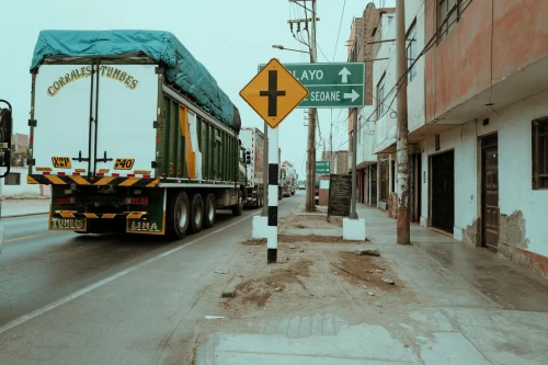 Tranquil street view with truck and signs in Trujillo, Peru, showcasing daily life in the city