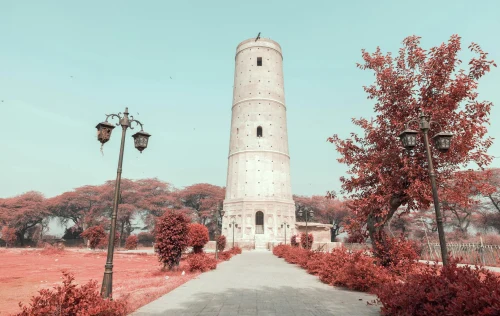Stunning view of Hiran Minar Tower surrounded by vibrant autumn foliage in Pakistan