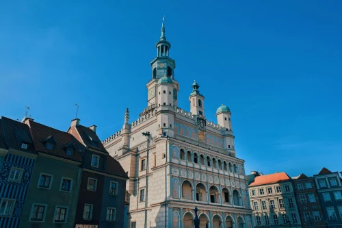 Low-angle view of Poznań Town Hall against a clear blue sky. Iconic renaissance architecture