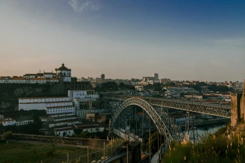 Beautiful view of the Eiffel Bridge in Porto, Portugal during golden hour. Scenic architecture and cityscape