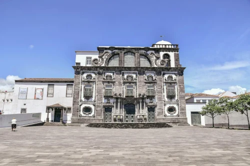 A beautiful Baroque-style church in São Miguel, Azores, under a clear blue sky