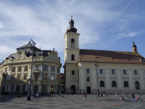 View of the historic Great Square in Sibiu, featuring iconic architecture under a clear blue sky