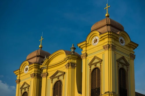 Close-up of St George Cathedral's towers in Timișoara, Romania, with a clear blue sky