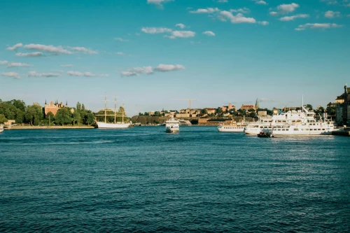 Sunny summer day on the Stockholm waterfront with cruise ships and iconic city skyline in view