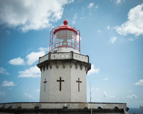 Iconic lighthouse standing tall under a blue sky at the Azores, Portugal