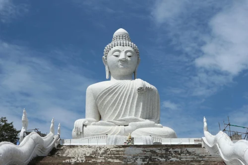 Majestic Big Buddha statue under blue sky, popular tourist landmark in Phuket, Thailand