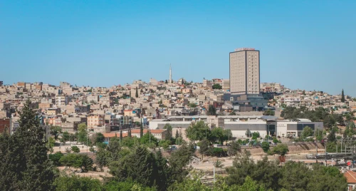 View of Gaziantep cityscape featuring distinctive architecture under a bright blue sky