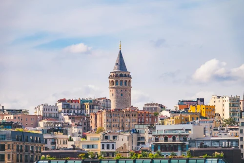 Colorful cityscape of Istanbul featuring the iconic Galata Tower amidst vibrant buildings on a sunny day