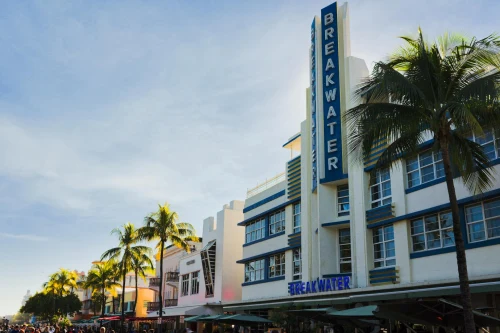 Art Deco Breakwater Hotel with palm trees in Miami Beach. Iconic South Beach architecture under a clear sky