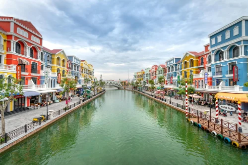 Vibrant buildings line a canal in Phu Quoc, Vietnam, showcasing colorful architecture