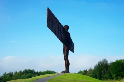 Iconic Angel of the North statue with a striking blue sky background in Newcastle, England